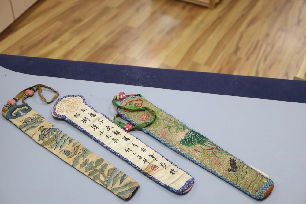 Three embroidered Chinese fan cases, one Kesi and woven with a tree, river and temple motifs, another with fine embroidered duck and li